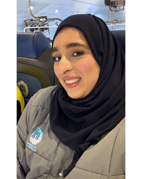 Fatima Abdulqader smiling warmly, sitting in a cozy home setting, reflecting her approachable and supportive personality as a Bahraini motherhood influencer.